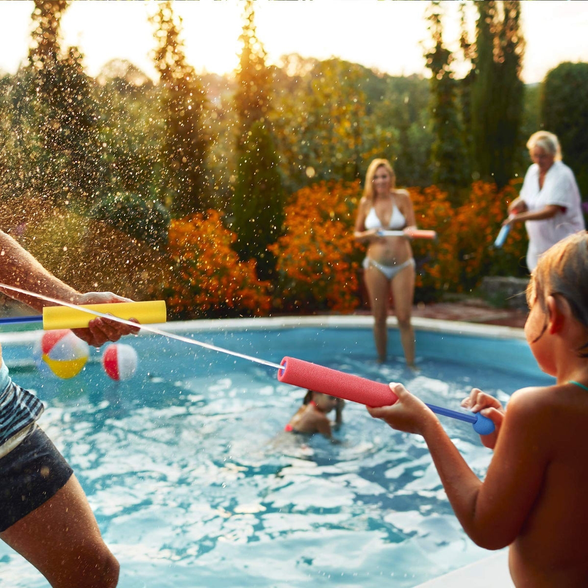 Duskie foam water gun set for kids, featuring colorful pool blasters in action during a sunny outdoor summer party.